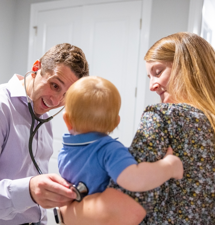 Doctor Weiss using a stethoscope on a baby boy