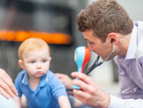 Doctor Weiss using a stethoscope on a toddler