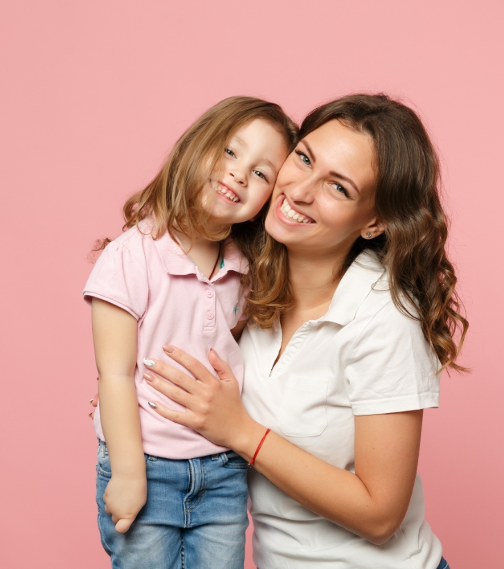 Mother and young daughter hugging